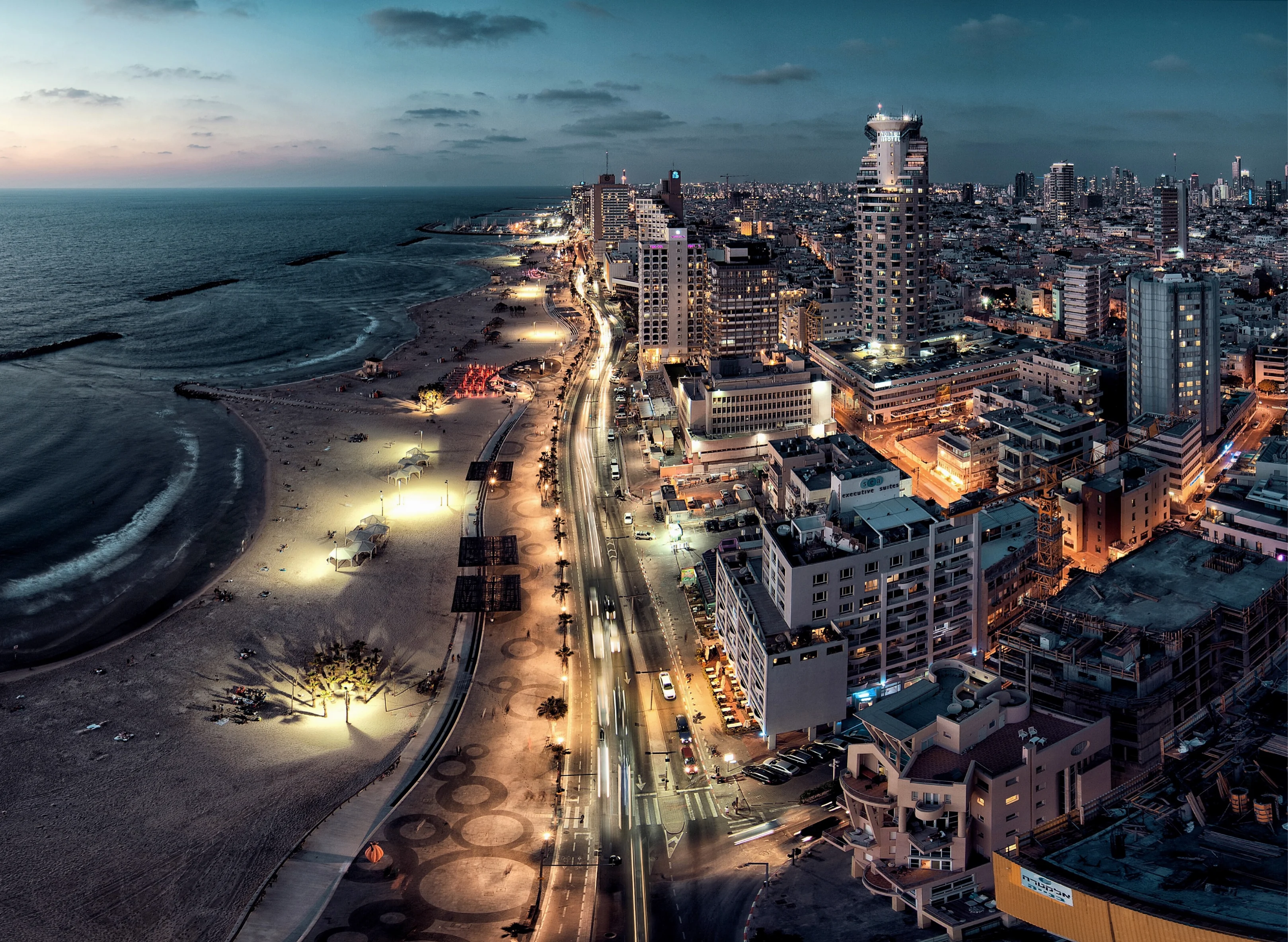 Israel coastline and city lights at dusk